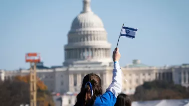 A child waves the flag of Israel at a rally during the March for Israel in Washington on the National Mall 