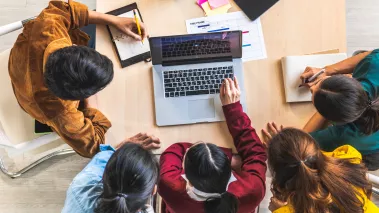 Students working around a table