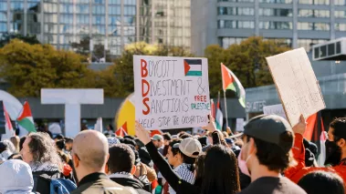 Protesters march in the city holding signs advocating for Boycott Divestment and Sanctions on October 28, 2023