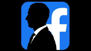 silhouette of Mark Zuckerberg in front of the Facebook logo