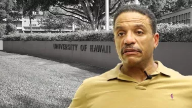 Law professor Ken Lawson with the entrance sign for the University of Hawai'i at Manoa in the background