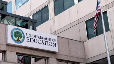 Exterior sign and US flag in front of the Department of Education offices in Washington