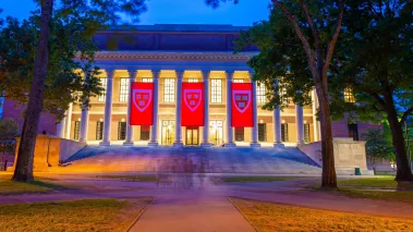 Harry Elkins Widener Memorial Library at Harvard University in Cambridge, Massachusetts with the columns lit up at night