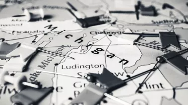 Map of the state of Michigan covered in little flag pins