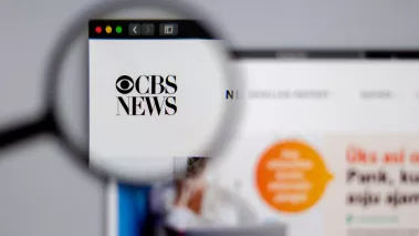 CBS logo visible through a magnifying glass