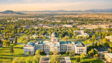 Drone view of the Montana State Capitol in Helena on a sunny afternoon with hazy sky caused by wildfires