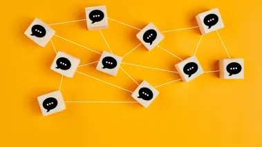 Wooden cubes with speech bubbles linked to each other with lines