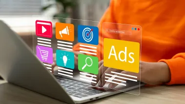 Person at a computer with a digital display showing advertisements