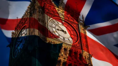 Union jack flag and iconic Big Ben at the palace of Westminster in London