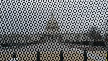 Capitol building as seen through security fence