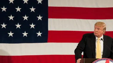 Donald Trump speaks in front of US flag at the First in the Nation Leadership Summit in Nashua New Hampshire on April 18, 2015