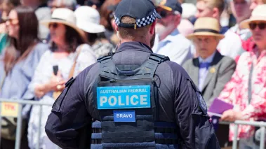A Canberra police officer standing in front of a crowd