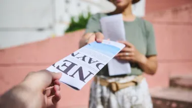 Person hands out flyers
