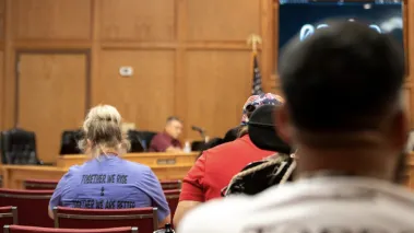 Uvalde teacher Nicole Ogburn sits at a Texas school board meeting in August 2023.