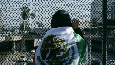 Immigration protestor standing over the Los Angeles 101 FWY in February 2025.