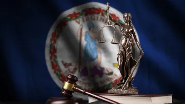 Virginia state flag with statue of lady justice and judge gavel (Image via Shutterstock)