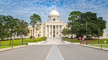 Alabama State Capitol in Montgomery with a blue and cloudy sky in the background (Image via Shutterstock.com)