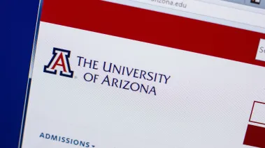 Homepage of University of Arizona website on a laptop display (Image via Shutterstock.com)