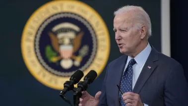 President Joe Biden delivers remarks with the presidential seal in the background (Image via Shutterstock.com)