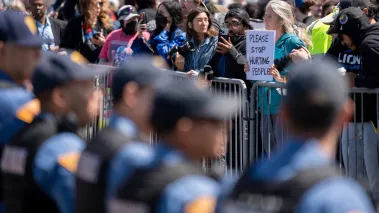 An anti-ICE protesters holds a sign opposing a line of New Jersey State Police during a rally in support of Immigration and Customs Enforcement outside Delaney Hall on May 30 2026, in Newark, New Jersey. (Image via Imagn / USAToday)