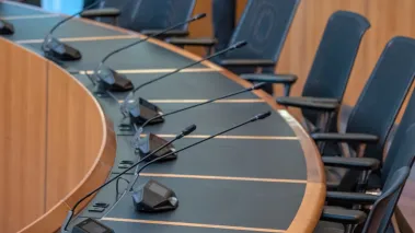 Empty seats for a city council meeting (Image via Shutterstock.com)