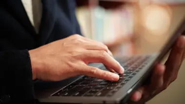student reads study on laptop