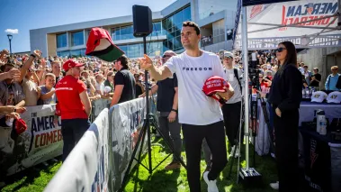 Charlie Kirk tossing hats before his last speech to Utah Valley University. (Image via Shutterstock.com)