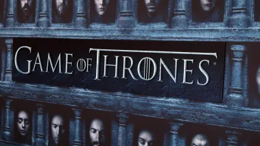 Game of Thrones season 6 premiere screening in Los Angeles with a poster showing the title of the show and faces of main characters.