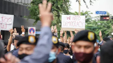 Protesters give 3-finger salute as they march during an anti-government mass protest in Bangkok Thailand. (Image via Shutterstock.com)