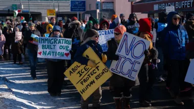 Minnesota protesters stand on the street holding signs
