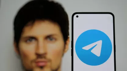 Telegram app logo on smartphone screen with Telegram founder Pavel Durov in the background