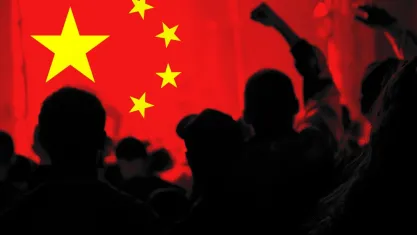 Silhouette of protesters against Chinese flag