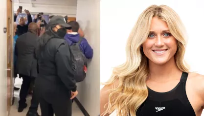 Security holding back protesters in a hallway at SFSU