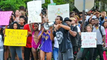 Protesters holding signs in the street
