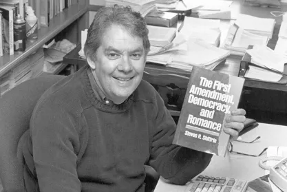 Steve Shiffrin holds his book "The First Amendment, Democracy, and Romance"