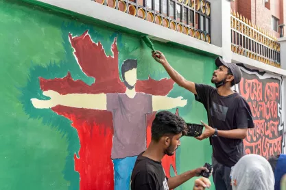 Students making graffiti art in memory of those killed in pro-democracy protest in Bangladesh