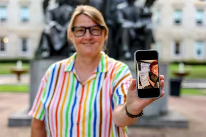 Photo of FIRE plaintiff Susan Hogarth holding up her phone showing her ballot selfie