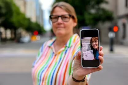 Photo of FIRE plaintiff Susan Hogarth holding up her phone showing her ballot selfie