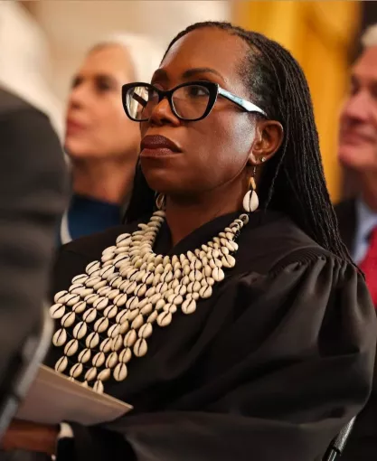 Justice Ketanji Brown Jackson at Trump Inauguration in 2024 wearing a distinctive collar adorned with cowrie shells, which are believed to offer protection from evil.