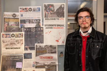 Retrograde editor Gregorio Olivares Gutierrez standing in front of old newspapers