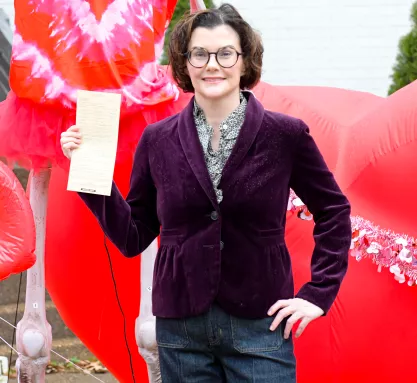 FIRE client Alexis Luttrell holding a copy of the citation from the City of Germantown