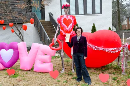 FIRE client Alexis Luttrell stands with her lawn skeletons in Germantown Tennessee