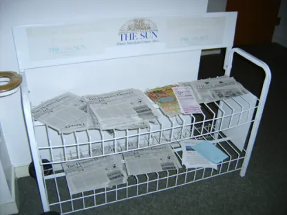 These photographs from May 20, 2006, show a newspaper distribution rack in Johns Hopkins University’s Wolman Hall, a dorm on campus, that displays copies of the Hopkins Donkey, a Democratic student publication, along with several advertisements from a pizza shop.