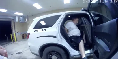 Bushart in a police car