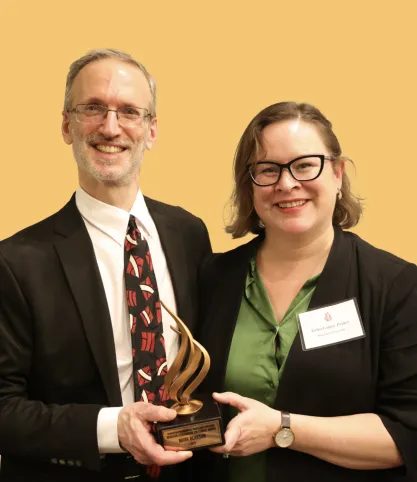 Professor Mark Berkson poses with colleague Erika Lopez Prater after receiving the FIRE Berkson Courageous Colleague Award in 2025.