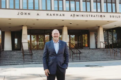 FIRE plaintiff Michael Balow standing in front of the John Hannah Administration Building at Michigan State University
