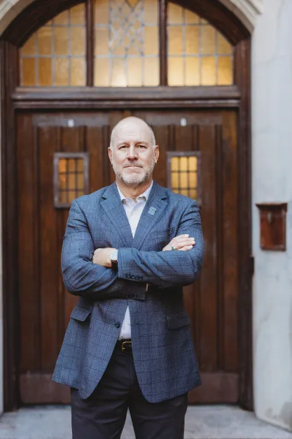 FIRE plaintiff Michael Balow standing in front of a door on the MSU campus.