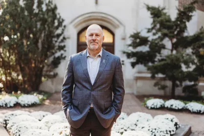FIRE plaintiff Michael Balow in a suit with his hands in his pockets on the MSU campus.