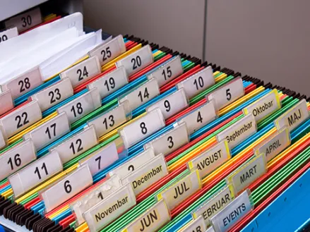 Open file cabinet with folders and many colored tabs