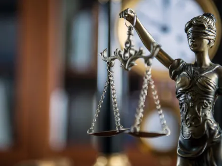 Law and Justice concept with gavel and scale in background in court library